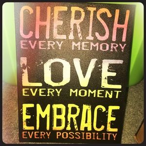 “Cherish love embrace” sign